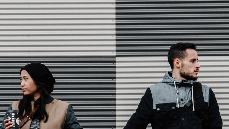 Man and woman looking away from each other.